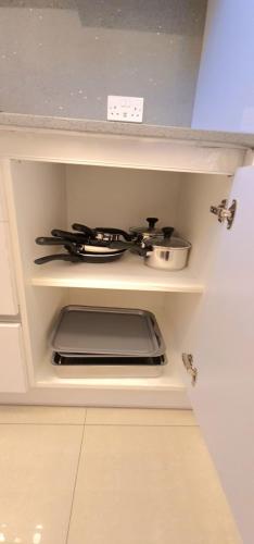 a kitchen drawer with pots and pans in it at London Luxury 3 bedroom flat, 2 bathrooms, Living Room, free parking, 4 mins to station, garden in Ilford
