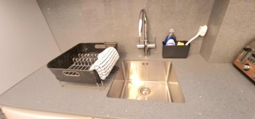 a kitchen counter with a sink and a sink at London Luxury 3 bedroom flat, 2 bathrooms, Living Room, free parking, 4 mins to station, garden in Ilford