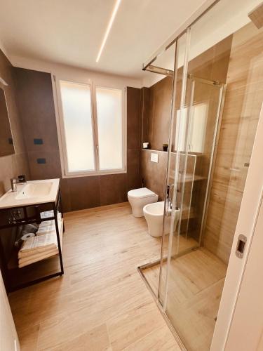 a bathroom with a shower and a toilet and a sink at CINQUE TERRE Hub Suite ART in La Spezia