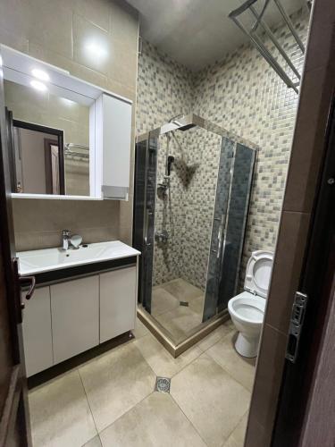 a bathroom with a shower and a sink and a toilet at ზღვის ულამაზესი ხედები in K'obulet'i