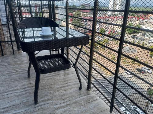 a table and chair on a balcony with a cup of coffee at ზღვის ულამაზესი ხედები in K'obulet'i