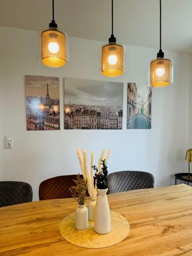 a wooden table with two vases on it with lights at Traumhaftes Familiendomizil in Scharbeutz - Strand 500m, kostenlos Parken, Garten in Scharbeutz