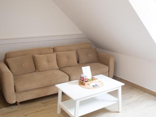 a living room with a couch and a table at MERSEA in Ustka