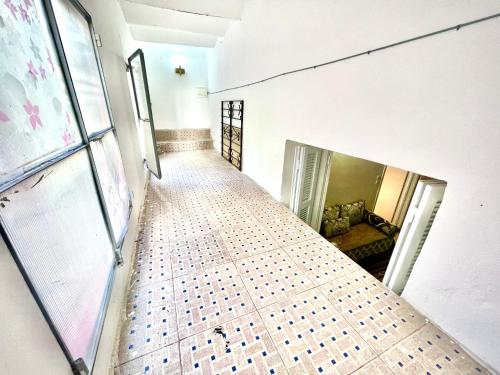 an empty hallway with a tiled floor in a building at Moroccan Place in Larache