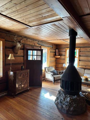 a living room with a fireplace in a log cabin at Rustic Beaverfoot Lodge Room N6 in Parson