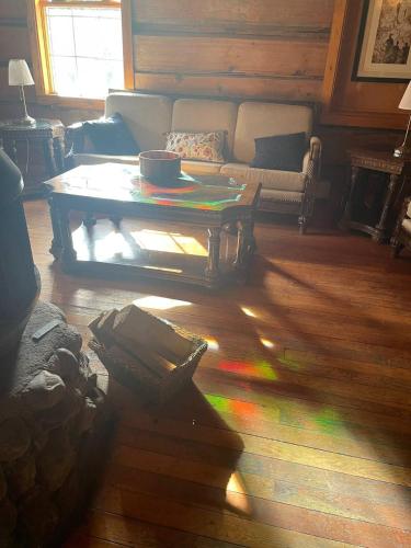 a living room with a coffee table and a couch at Rustic Beaverfoot Lodge Room N6 in Parson