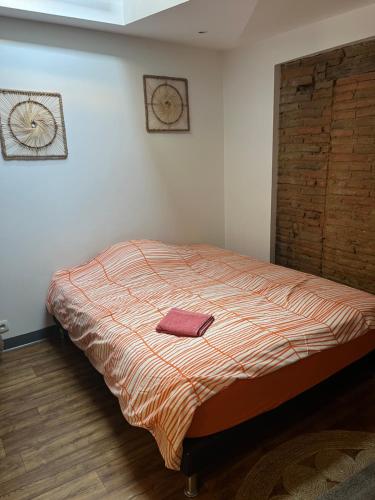 une chambre avec un lit avec une serviette dessus dans l'établissement Maison avec garage, à Montauban