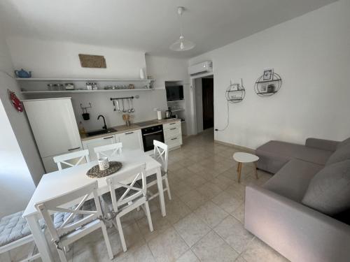a kitchen and living room with a table and chairs at Holiday home Omišalj in Omišalj