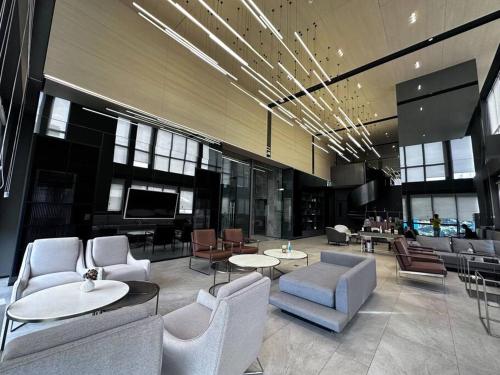 a lobby with chairs and tables in a building at S87-7052 BTS Onnut High Floor Gym Swim Good View in Bangkok