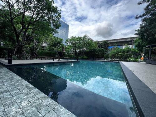 a swimming pool with blue water in a city at S87-7052 BTS Onnut High Floor Gym Swim Good View in Bangkok