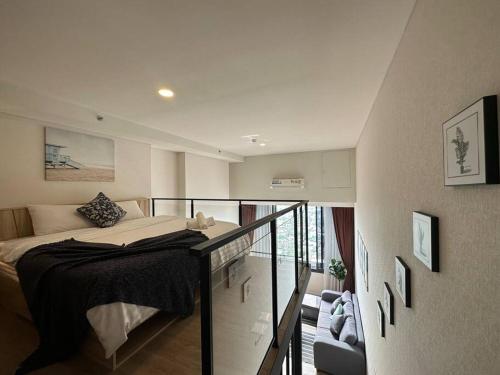 a bedroom with a bed and a balcony at S87-7052 BTS Onnut High Floor Gym Swim Good View in Bangkok
