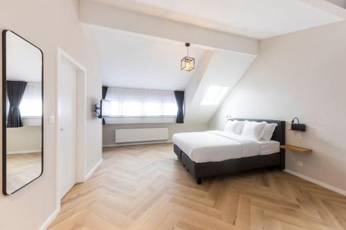 a bedroom with a bed and a large mirror at Midi Stay Brussels in Brussels