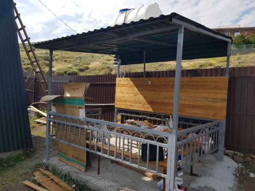 a goat pen with a canopy on a fence at Oasis Home on Lake Sevan in Shorzha