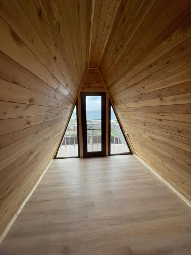 a large wooden room with a large window at Oasis Home on Lake Sevan in Shorzha