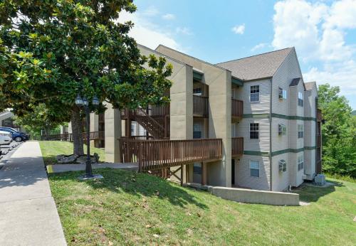 a apartment building with a deck on the side of it at Beautiful Branson Getaway-Next to Silver Dollar City &Tablerock-Family Amenities in Branson