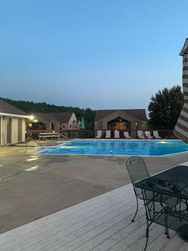 a swimming pool with a chair next to a building at Beautiful Branson Getaway-Next to Silver Dollar City &Tablerock-Family Amenities in Branson
