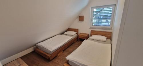a small room with two beds and a window at Family house Kranjska Gora in Kranjska Gora