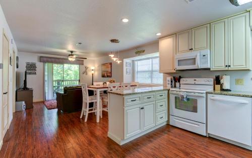 a kitchen with white cabinets and a table in a room at Beautiful Branson Getaway-Next to Silver Dollar City &Tablerock-Family Amenities in Branson