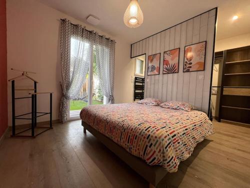 a bedroom with a bed and a large window at Spa, Climatisation, Piscine chauffée, Pétanque et Calme au Bassin d'Arcachon in Le Teich