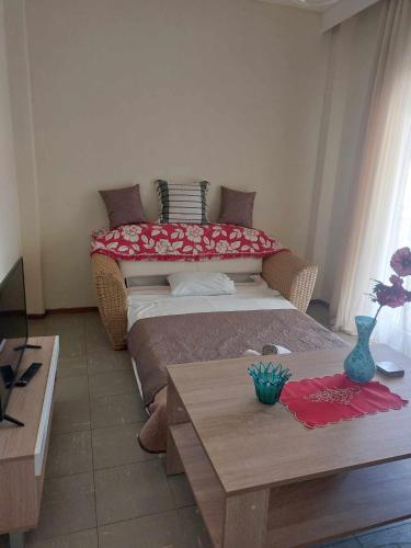 a small room with a bed and a table at Luminosa Seaview Apartment in Iraklitsa