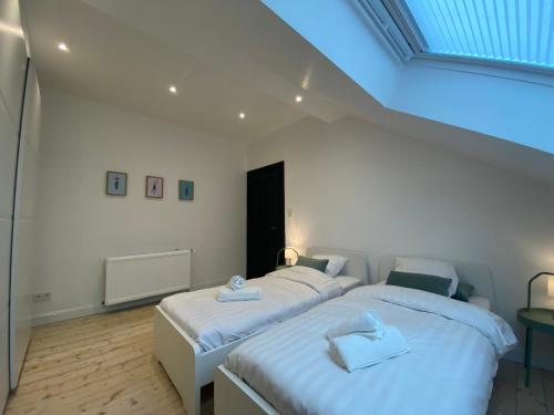 a bedroom with two beds with towels on them at Old Town Suites in Malmedy
