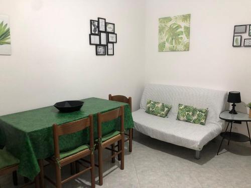 a living room with a table and a couch at Casa Turusele in Santa Maria Navarrese