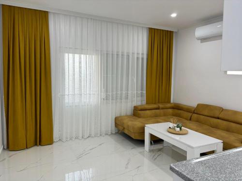 a living room with a couch and a table at Pami in Néa Péramos