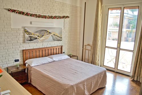 a bedroom with a bed and a brick wall at Casa Fiume in Mantova