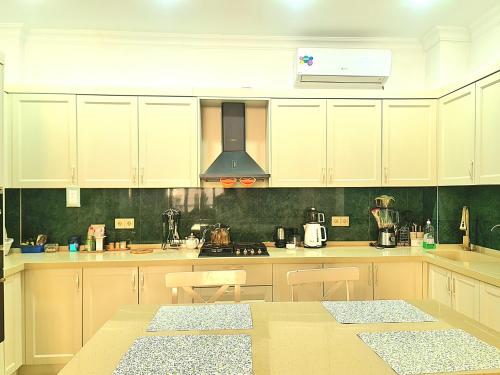 a kitchen with white cabinets and a counter top at DêlMar 22 in Mardakan