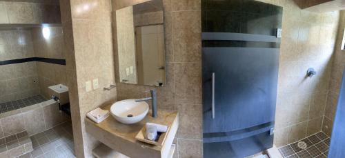 a bathroom with a sink and a mirror at Hotel y Aguas Termales de Chignahuapan in Chignahuapan