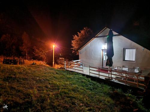 a house with a light on the side of it at night at Vila Vlasina in Vlasina Rid