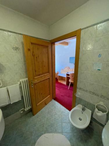 a bathroom with a toilet and a sink at Sporting Hotel in Passo del Tonale