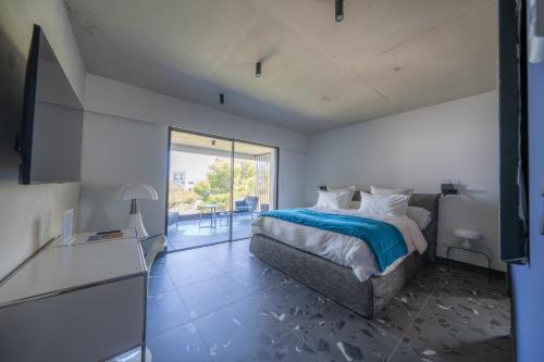 a bedroom with a bed and a large window at Suite 28 in Treilles