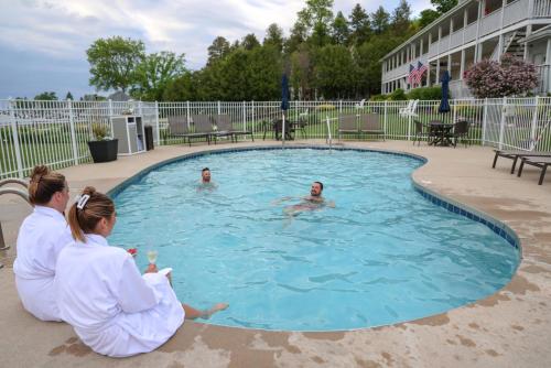 a group of people sitting in a swimming pool at The Water Street Inn in Ephraim