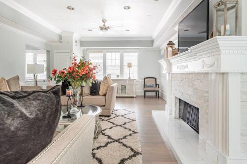 a living room with a fireplace and a couch at LUXURY 6000 sqft Mansion in Downtown Orlando Sleeps 12 in Orlando