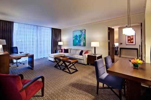 a hotel room with a living room with a couch and a table at Fairmont Pittsburgh in Pittsburgh
