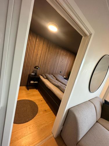a small room with a bed and a mirror at ONS 2024 apartment for rent - panoramic view, private gym,parking - close to city centre in Stavanger