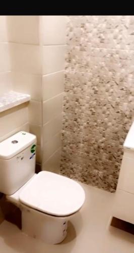 a bathroom with a white toilet and a shower at Résidence Al hambra in Tangier