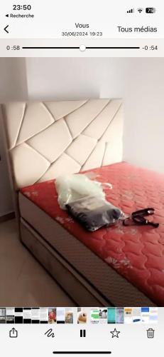 a picture of a bed with a red and white bedspread at Résidence Al hambra in Tangier