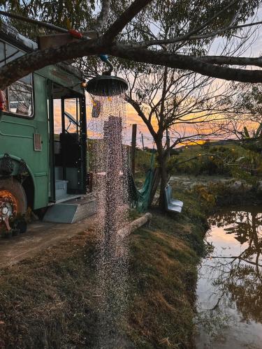 a fire hydrant spraying water in a park at Hospedagem Ônibus na Roça em Serra ES in Serra