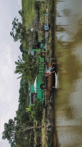 an aerial view of a house on the side of a river at Hospedagem Ônibus na Roça em Serra ES in Serra