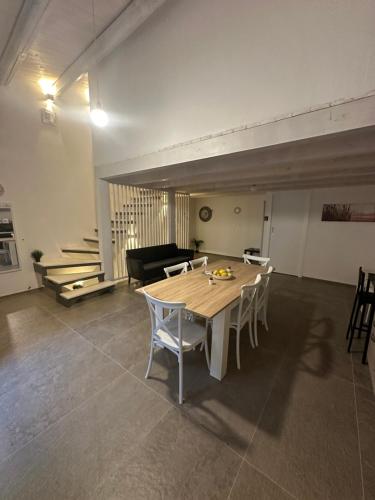 a living room with a wooden table and chairs at L'Oasi del Tirreno in Lascari