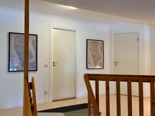 a white room with two doors and a staircase at Sjönära Villa Lilla Emma, Jädraås, nära Kungsberget in Jädraås