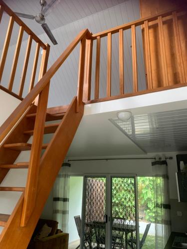 a wooden staircase in a house with a ceiling at Tiki Ora Lodge - HURA in Bora Bora