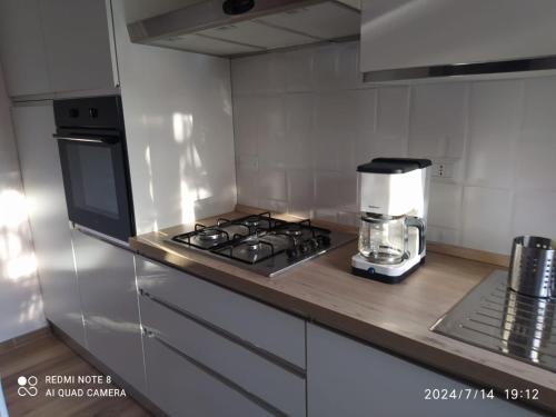 a kitchen with a stove and a coffee maker on a counter at Casa vacanze Aielli Risorgimento in Aielli