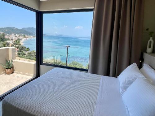 a bedroom with a bed and a large window at Palms and Spas Villas Retreat in Mesongi