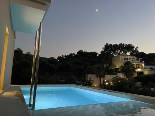 a swimming pool on the side of a house at Palms and Spas Villas Retreat in Mesongi