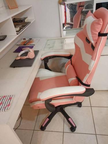 ein rosa Bürostuhl an einem Schreibtisch in der Unterkunft Apartamento central em Contagem in Contagem
