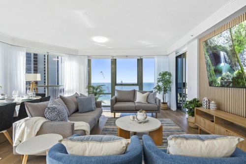 a living room with a couch and a table at Sun City - QStay in Gold Coast