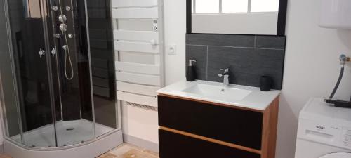 a bathroom with a sink and a shower at Maison de village rénovée in Lédignan